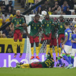 
              Cameroon's defensive wall jumps to block a free kick of Brazil's Dani Alves, left, during the World Cup group G soccer match between Cameroon and Brazil, at the Lusail Stadium in Lusail, Qatar, Friday, Dec. 2, 2022. (AP Photo/Natacha Pisarenko)
            