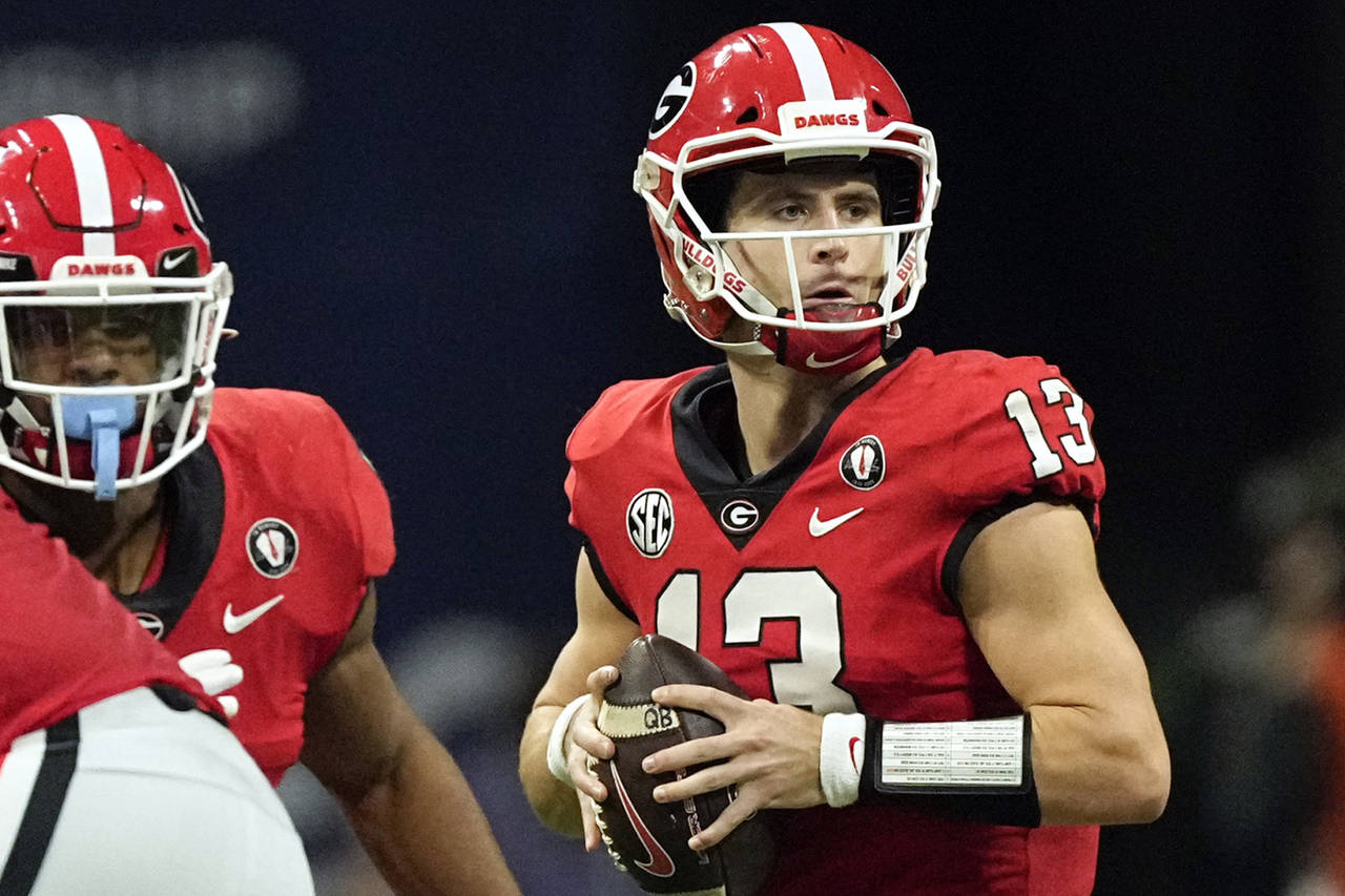 FILE - Georgia quarterback Stetson Bennett (13) looks for an open receiver in the first half of the...