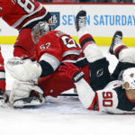 
              Carolina Hurricanes goaltender Pyotr Kochetkov watches the puck after colliding with New Jersey Devils' Tomas Tatar (90) during the first period of an NHL hockey game in Raleigh, N.C., Tuesday, Dec. 20, 2022. (AP Photo/Karl B DeBlaker)
            