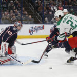 
              Columbus Blue Jackets' Daniil Tarasov, left, makes a save against Dallas Stars' Mason Marchment (27) during the first period of an NHL hockey game on Monday, Dec. 19, 2022, in Columbus, Ohio. (AP Photo/Jay LaPrete)
            
