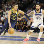 
              Indiana Pacers guard Tyrese Haliburton (0) drives on Minnesota Timberwolves guard Austin Rivers (25) in the third quarter of an NBA basketball game, Wednesday, Dec. 7, 2022, in Minneapolis. (AP Photo/Andy Clayton-King)
            