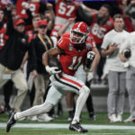 
              Georgia wide receiver Arian Smith (11) runs for the end zone for a touchdown against Ohio State during the second half of the Peach Bowl NCAA college football semifinal playoff game, Saturday, Dec. 31, 2022, in Atlanta. (AP Photo/John Bazemore)
            