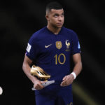 
              France's Kylian Mbappe the Golden Boot award for top goalscorer of the tournament after the World Cup final soccer match between Argentina and France at the Lusail Stadium in Lusail, Qatar, Sunday, Dec.18, 2022. (AP Photo/Manu Fernandez)
            