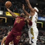 
              Cleveland Cavaliers guard Donovan Mitchell (45) shoots next to Indiana Pacers center Myles Turner (33) during the first half of an NBA basketball game in Indianapolis, Thursday, Dec. 29, 2022. (AP Photo/AJ Mast)
            