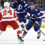 
              Tampa Bay Lightning center Ross Colton (79) moves the puck in front of Detroit Red Wings center Pius Suter (24) during the second period of an NHL hockey game Tuesday, Dec. 6, 2022, in Tampa, Fla. (AP Photo/Chris O'Meara)
            