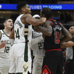 
              Milwaukee Bucks' Giannis Antetokounmpo (34) and Wesley Matthews (23) hold back Chicago Bulls' DeMar DeRozan (11) who exchanges words with Bucks' Grayson Allen (12) after a foul during the second half of an NBA basketball game Wednesday, Dec. 28, 2022, in Chicago. (AP Photo/Quinn Harris)
            