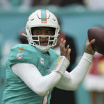 
              FILE - Miami Dolphins quarterback Tua Tagovailoa (1) looks to pass during the first half of an NFL football game against the Green Bay Packers, Sunday, Dec. 25, 2022, in Miami Gardens, Fla. Dolphins quarterback Tagovailoa sustained his second concussion of the season in last week’s loss to Green Bay, Miami coach Mike McDaniel confirmed Wednesday, Dec. 28. Tagovailoa has not been officially ruled out for Sunday's pivotal game at New England, though it's unknown when the Dolphins will see him on the field again. (AP Photo/Jim Rassol, File)
            