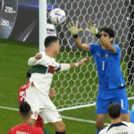 
              Morocco's goalkeeper Yassine Bounou, right, makes a save in front of Portugal's Cristiano Ronaldo during the World Cup quarterfinal soccer match between Morocco and Portugal, at Al Thumama Stadium in Doha, Qatar, Saturday, Dec. 10, 2022. (AP Photo/Luca Bruno)
            