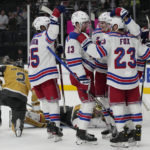 
              New York Rangers left wing Alexis Lafrenière (13) celebrates with teammates after scoring against the Vegas Golden Knights during the third period of an NHL hockey game Wednesday, Dec. 7, 2022, in Las Vegas. (AP Photo/John Locher)
            
