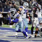 
              Dallas Cowboys running back Ezekiel Elliott (21) scores a touchdown during the second half of an NFL football game against the Houston Texans, Sunday, Dec. 11, 2022, in Arlington, Texas. (AP Photo/Michael Ainsworth)
            