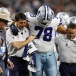 
              Dallas Cowboys offensive tackle Terence Steele (78) is helped off the field after he was injured in the first half of an NFL football game against the Houston Texans, Sunday, Dec. 11, 2022, in Arlington, Texas. (AP Photo/Ron Jenkins)
            