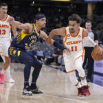
              Atlanta Hawks' Trae Young (11) drives against Indiana Pacers' Andrew Nembhard (2) during the first half of an NBA basketball game Tuesday, Dec. 27, 2022, in Indianapolis. (AP Photo/Darron Cummings)
            