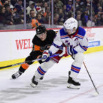 
              New York Rangers' Jacob Trouba, right, and Philadelphia Flyers' Owen Tippett battle for the puck during the second period of an NHL hockey game, Saturday, Dec. 17, 2022, in Philadelphia. (AP Photo/Derik Hamilton)
            
