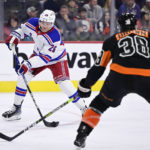 
              New York Rangers' Jimmy Vesey (26) takes a shot to score a goal during the third period of an NHL hockey game against the Philadelphia Flyers, Saturday, Dec. 17, 2022, in Philadelphia. (AP Photo/Derik Hamilton)
            