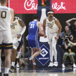 
              West Virginia forward Josiah Harris (22) reacts after scoring against Buffalo during the first half of an NCAA college basketball game in Morgantown, W.Va., Sunday, Dec. 18, 2022. (AP Photo/Kathleen Batten)
            