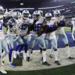
              Dallas Cowboys' DaRon Bland celebrates his interception with teammates during the second half of an NFL football game against the Philadelphia Eagles Saturday, Dec. 24, 2022, in Arlington, Texas. (AP Photo/Ron Jenkins)
            