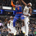 
              New York Knicks guard RJ Barrett (9) shoots around Indiana Pacers center Myles Turner (33) during the first half of an NBA basketball game in Indianapolis, Sunday, Dec. 18, 2022. (AP Photo/AJ Mast)
            