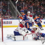 
              Montreal Canadiens goalie Jake Allen (34) is scored on by Edmonton Oilers' Darnell Nurse (25) as Johnathan Kovacevic (26) tries to defend during the second period of an NHL hockey game, Saturday, Dec. 3, 2022 in Edmonton, Alberta. (Jason Franson/The Canadian Press via AP)
            