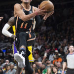 
              Atlanta Hawks guard Trae Young drives and scores during the second half of an NBA basketball game against the Los Angeles Lakers, Friday, Dec. 30, 2022, in Atlanta. (AP Photo/Hakim Wright Sr.)
            