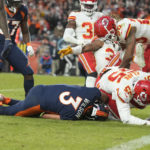 
              Denver Broncos quarterback Russell Wilson, right, goes down as he is tackled by Kansas City Chiefs defensive end Frank Clark (55) during the second half of an NFL football game Sunday, Dec. 11, 2022, in Denver. (AP Photo/David Zalubowski)
            
