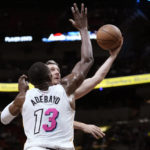 
              Chicago Bulls guard Goran Dragic, right, shoots as Miami Heat center Bam Adebayo (13) defends during the first half of an NBA basketball game, Tuesday, Dec. 20, 2022, in Miami. (AP Photo/Lynne Sladky)
            