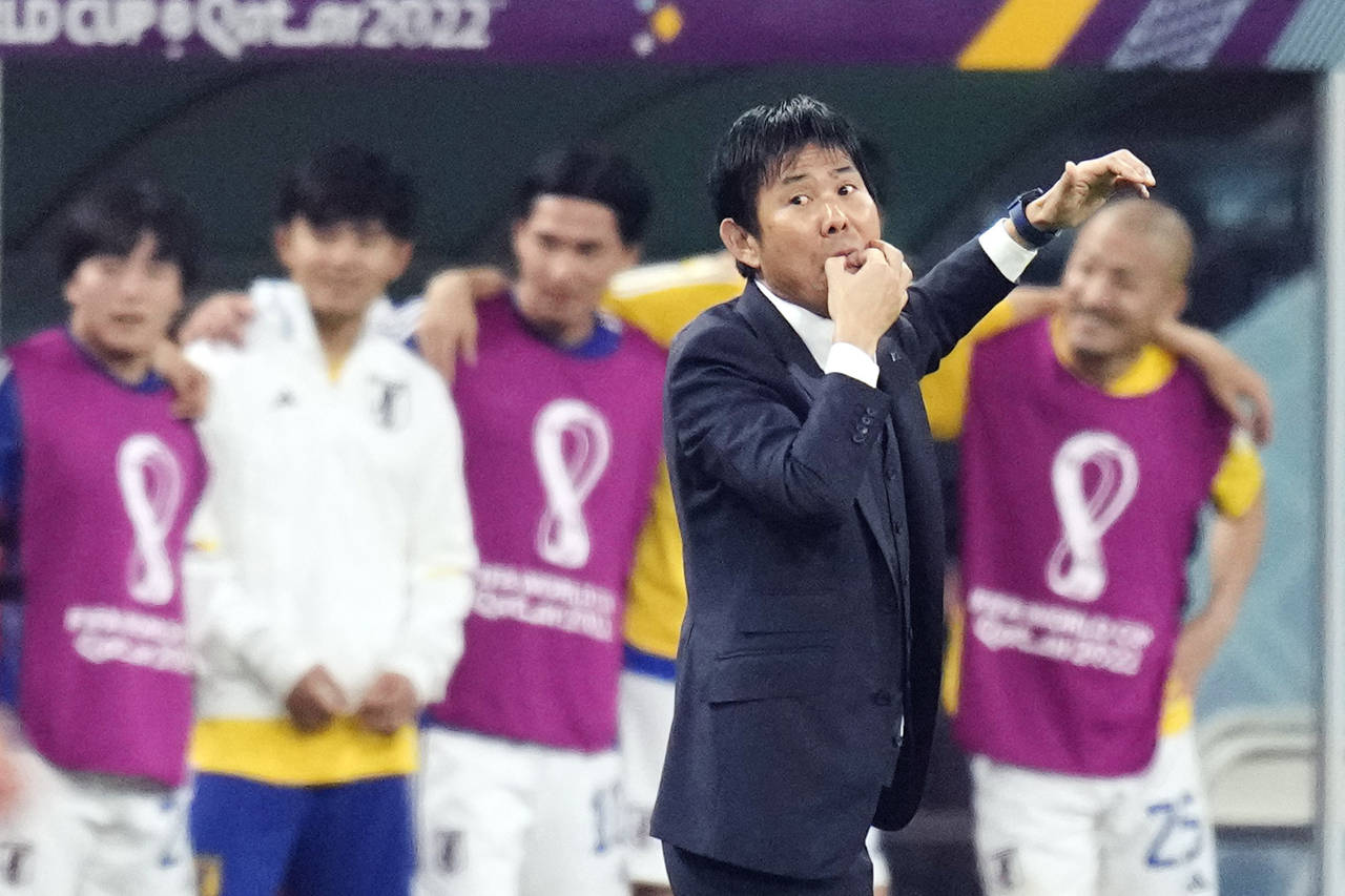 Japan's head coach Hajime Moriyasu whistles during the World Cup group E soccer match between Japan...