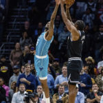 
              LA Clippers forward Kawhi Leonard shoots over Charlotte Hornets forward Jalen McDaniels to take the lead in the final seconds of the second half of an NBA basketball game on, Monday, Dec. 5, 2022, in Charlotte, N.C. (AP Photo/Scott Kinser)
            