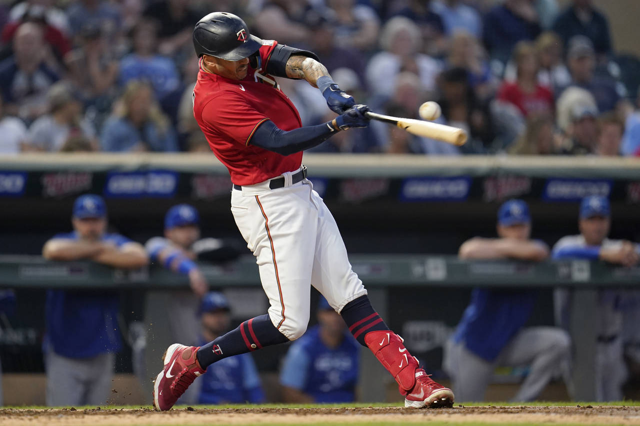 FILE - Minnesota Twins' Carlos Correa hits an RBI double during the third inning of a baseball game...