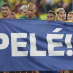 
              Brazilian players hold a banner in honour of the 82-year-old Brazilian soccer legend Pele who is in a hospital in San Paulo recovering from a respiratory infection at the end of the World Cup round of 16 soccer match between Brazil and South Korea at the Stadium 974 in Doha, Qatar, Monday, Dec. 5, 2022. (AP Photo/Jin-Man Lee)
            