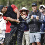 
              Tiger Woods tees off on the 4th hole during the final round of the PNC Championship golf tournament Sunday, Dec. 18, 2022, in Orlando, Fla. (AP Photo/Kevin Kolczynski)
            