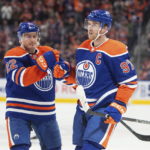 
              Edmonton Oilers' Tyson Barrie (22) and Connor McDavid (97) celebrate a goal against the Montreal Canadiens during the second period of an NHL hockey game, Saturday, Dec. 3, 2022 in Edmonton, Alberta. (Jason Franson/The Canadian Press via AP)
            