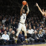 
              Butler guard Chuck Harris, left, shoots in front of Connecticut guard Joey Calcaterra, right, in the first half of an NCAA college basketball game in Indianapolis, Saturday, Dec. 17, 2022. (AP Photo/AJ Mast)
            