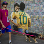 
              A man walks his dog walk past a mural showing Brazilian soccer legend Pele and Argentina late soccer star Diego Armando Maradona in Buenos Aires, Argentina, Thursday, Dec. 29, 2022. Pele, who won a record three World Cups has died at the age of 82. (AP Photo/Natacha Pisarenko)
            