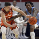 
              North Carolina's Caleb Love, right, steals a pass intended for Virginia Tech's Hunter Cattoor in the first half an NCAA college basketball game in Blacksburg Va., Sunday Dec. 4, 2022. (Matt Gentry/The Roanoke Times via AP)
            