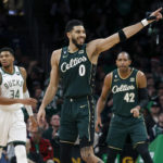 
              Boston Celtics forward Jayson Tatum (0) celebrates after making a basket as teammate Al Horford (42) and Milwaukee Bucks forward Giannis Antetokounmpo (34) look on during the second half of an NBA basketball game, Sunday, Dec. 25, 2022, in Boston. (AP Photo/Mary Schwalm)
            