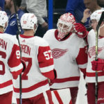 
              Detroit Red Wings goaltender Ville Husso (35) celebrates with teammates, including defenseman Olli Maatta (2), left wing David Perron (57) and defenseman Jake Walman (96) after an NHL hockey game against the Tampa Bay Lightning Tuesday, Dec. 6, 2022, in Tampa, Fla. (AP Photo/Chris O'Meara)
            