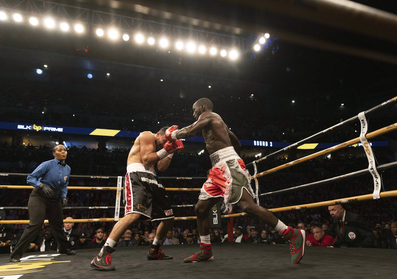 Terence Crawford, right, fights David Avanesyan during a World Boxing Organization welterweight wor...