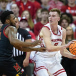 
              Wisconsin's Tyler Wahl (5) looks to pass the ball as Maryland's Donta Scott (24) defends during the first half of an NCAA college basketball game Tuesday, Dec. 6, 2022, in Madison, Wis. (AP Photo/Andy Manis)
            