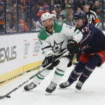 
              Dallas Stars' Luke Glendening, left, looks for an open pass as Columbus Blue Jackets' Marcus Bjork defends during the third period of an NHL hockey game on Monday, Dec. 19, 2022, in Columbus, Ohio. (AP Photo/Jay LaPrete)
            