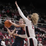 
              Gonzaga guard Payton Muma (3) drives to the basket against Stanford forward Brooke Demetre (21) during the first half of an NCAA college basketball game in Stanford, Calif., Sunday, Dec. 4, 2022. (AP Photo/Tony Avelar)
            