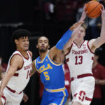 
              Stanford guard Michael Jones (13) looks to pass as UCLA guard Amari Bailey (5) defends against forward Spencer Jones (14) during the first half of an NCAA college basketball game in Stanford, Calif., Thursday, Dec. 1, 2022. (AP Photo/Godofredo A. Vásquez)
            