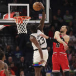 
              Minnesota Timberwolves forward Nathan Knight (13) goes up to the basket against Chicago Bulls guard Zach LaVine (8) during the first half of an NBA basketball game Sunday, Dec. 18, 2022, in Minneapolis. (AP Photo/Stacy Bengs)
            