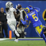 
              Las Vegas Raiders wide receiver Davante Adams, left, makes a catch as Los Angeles Rams cornerback Jalen Ramsey defends during the first half of an NFL football game Thursday, Dec. 8, 2022, in Inglewood, Calif. (AP Photo/Mark J. Terrill)
            