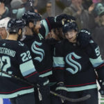
              Seattle Kraken forward Shane Wright, right, is congratulated by teammates forward Oliver Bjorkstrand, left, and defenseman Adam Larsson after scoring a goal during the first period of an NHL hockey game, Tuesday, Dec. 6, 2022, in Seattle. (AP Photo/Stephen Brashear)
            