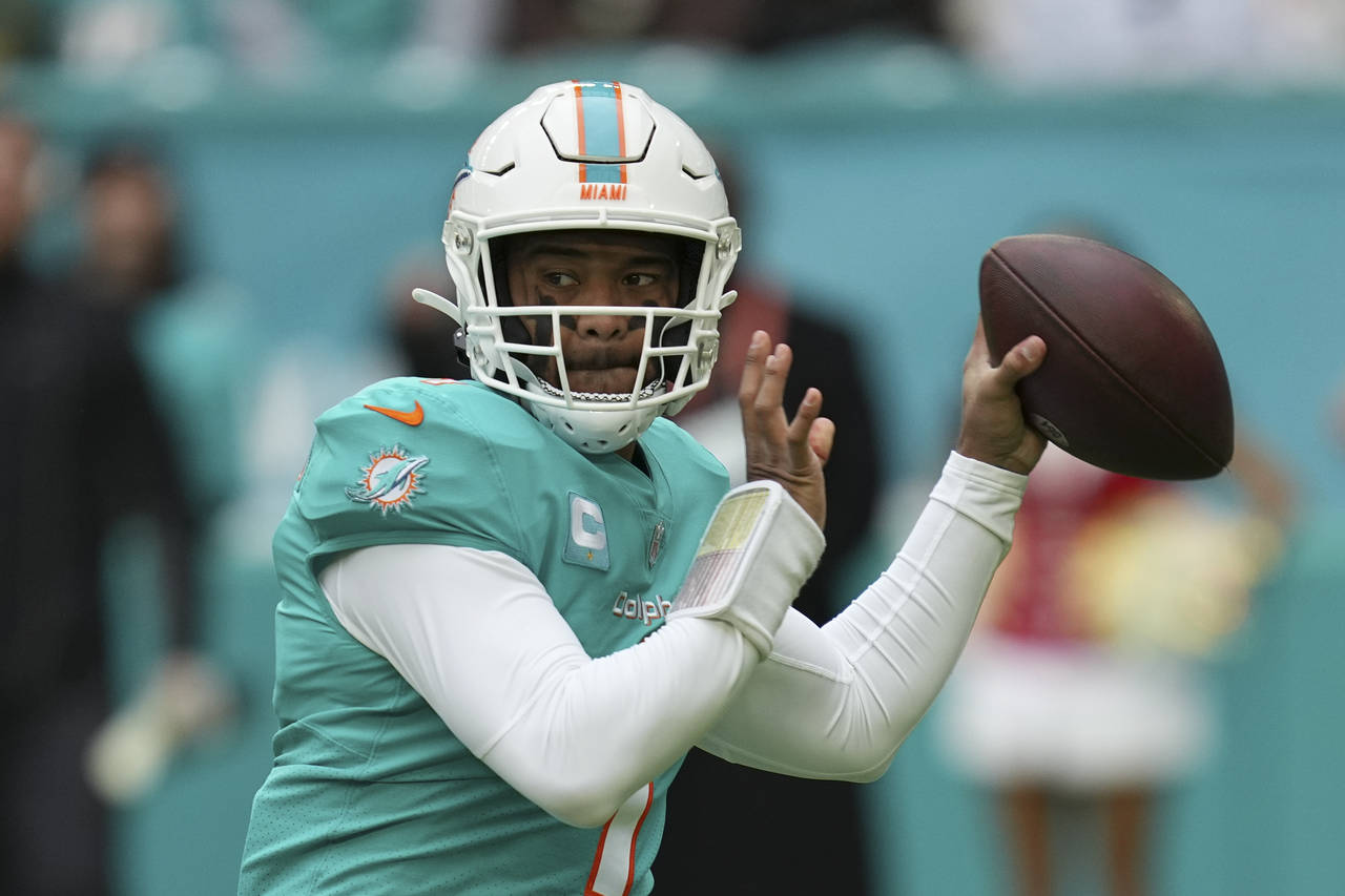 Miami Dolphins quarterback Tua Tagovailoa (1) looks to pass during the first half of an NFL footbal...