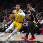 
              Los Angeles Lakers guard Russell Westbrook drives against Atlanta Hawks guard Aaron Holiday during the first half of an NBA basketball game Friday, Dec. 30, 2022, in Atlanta. (AP Photo/Hakim Wright Sr.)
            