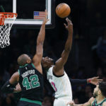 
              Boston Celtics' Al Horford (42) blocks a shot by Miami Heat's Bam Adebayo (13) during the first half of an NBA basketball game Friday, Dec. 2, 2022, in Boston. (AP Photo/Michael Dwyer)
            