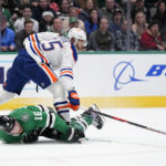 
              Dallas Stars center Joe Pavelski (16) attempts to take control of the puck after falling to the ice against Edmonton Oilers' Darnell Nurse  in the first period of an NHL hockey game, Wednesday, Dec. 21, 2022, in Dallas. (AP Photo/Tony Gutierrez)
            