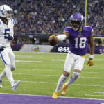
              Minnesota Vikings wide receiver Justin Jefferson (18) catches an 8-yard touchdown pass ahead of Indianapolis Colts cornerback Stephon Gilmore (5) during the second half of an NFL football game, Saturday, Dec. 17, 2022, in Minneapolis. (AP Photo/Andy Clayton-King)
            