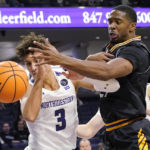 
              Northwestern guard Ty Berry, left, and Prairie View A&M forward Nikkei Rutty battle for a rebound during the first half of an NCAA college basketball game in Evanston, Ill., Sunday, Dec. 11, 2022. (AP Photo/Nam Y. Huh)
            